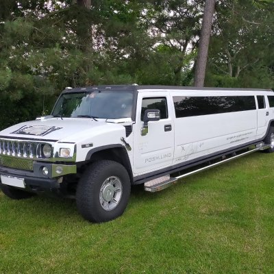 White stretch Hummer limousine parked on a lawn