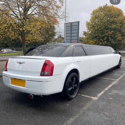 Rear view of a white stretch Chrysler 300 limousine