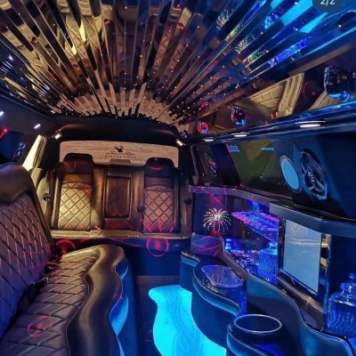 Illuminated party interior of a stretch limousine with bar and lounge seating