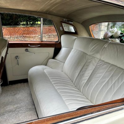 White leather rear seats of a classic Rolls-Royce wedding car