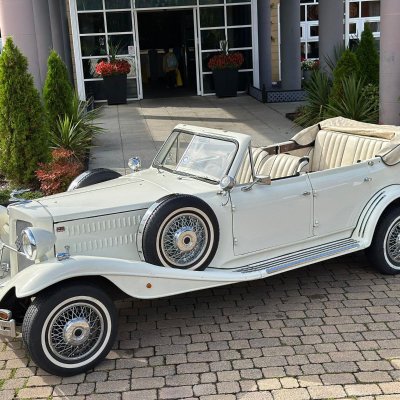Ivory Beauford convertible wedding car outside a hotel entrance
